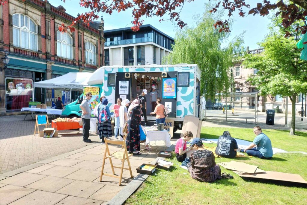 The Cholavan parked by grass in a town centre