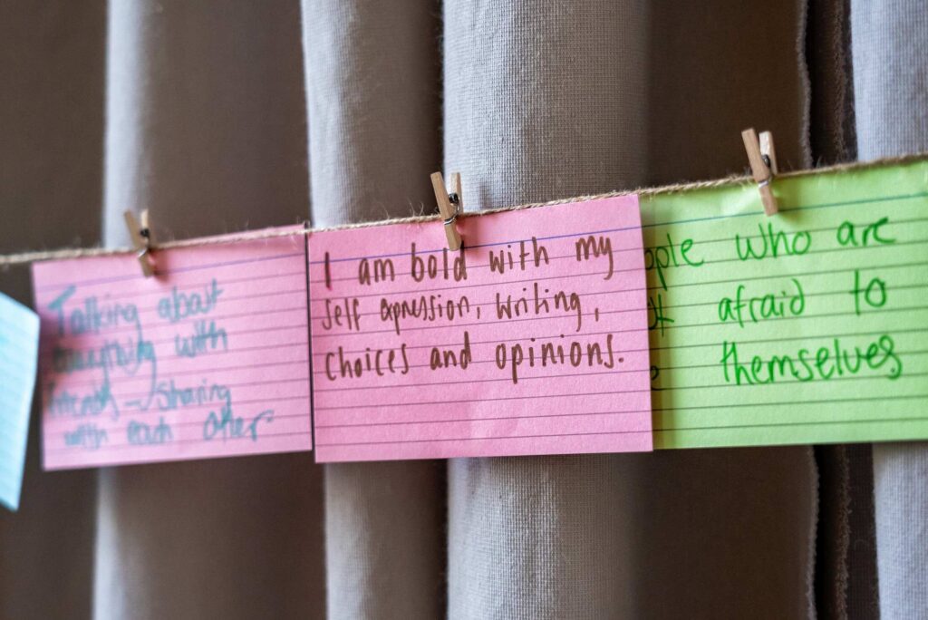 Note cards pinned to string with wooden clips
